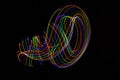 Long exposure photography made with light paint of various colors on a black background, waves, curves and swirls, curvilinear or