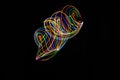 Long exposure photography made with light paint of various colors on a black background, waves, curves and swirls, curvilinear or