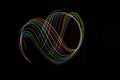 Long exposure photography made with light paint of various colors on a black background, waves, curves and swirls, curvilinear or