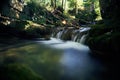 Long exposure of a river creek with a small waterfall. Sunset and strong detail bokeh view. blue calm warm water Royalty Free Stock Photo