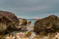 Long exposure of a rocky beach at Oropos in Greece. Royalty Free Stock Photo