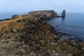 Long exposure seascape of the cliffs of Papoa island in Carvoeiro cape from the sea at sunrise in a cloudy day, Atlantic coast, Royalty Free Stock Photo