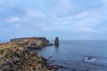 Long exposure seascape of the cliffs of Papoa island in Carvoeiro cape from the sea at sunrise in a cloudy day, Atlantic coast, Royalty Free Stock Photo