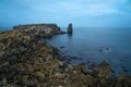 Long exposure seascape of the cliffs of Papoa island in Carvoeiro cape from the sea at sunrise in a cloudy day, Atlantic coast, Royalty Free Stock Photo