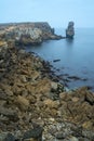 Long exposure seascape of the cliffs of Papoa island in Carvoeiro cape from the sea at sunrise in a cloudy day, Atlantic coast, Royalty Free Stock Photo