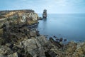 Long exposure seascape of the cliffs of Papoa island in Carvoeiro cape from the sea at sunrise in a cloudy day, Atlantic coast, Royalty Free Stock Photo