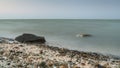 Long exposure seascape. in the foreground stones. Pink sunrise sunset