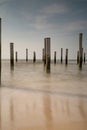 Long exposure seascape. Taken at the North Sea in Petten with the pole village in the sea, Blue sky, sun and shodows