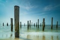 Long exposure seascape. Taken at the North Sea in Petten with the pole village in the sea, Blue sky, sun and shodows