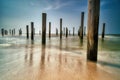 Long exposure seascape. Taken at the North Sea in Petten with the pole village in the sea, Blue sky, sun and shodows