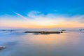 Long exposure shot of calmness sea and the rock in sunset