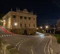 Long exposure shot of car light trails on a road near the Palazzo Medolago Albani