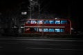 Long exposure shot of a City bus at night in motion in a bustling urban area
