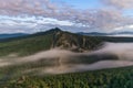 Long exposure shot of clouds flowing around rocky mountain in Aygir Royalty Free Stock Photo