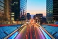 Long exposure shot of a downtown street at sunset. Skyscrapers on background with traffic lights. Brussels, Belgium. Royalty Free Stock Photo