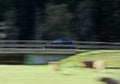 Long exposure shot of an epic black tesla model 3 car driving at high speed on the highway