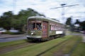 Long exposure shot of a green trolley in New Orleans on St Charles street
