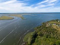 Long exposure shot of an island with beautiful ocean water under a blue sky. Royalty Free Stock Photo