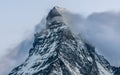 Long exposure shot of Matterhorn snowy mountain summit with cloud passing in front of the mount at dusk during summer in Swiss Royalty Free Stock Photo