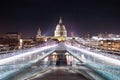 Long exposure shot of the millennium bridge surrounded by skyscrapers and buildings Royalty Free Stock Photo