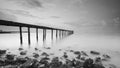 Long exposure shot of old broken jetty during pastel sunset. Royalty Free Stock Photo