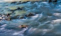 Long exposure shot of Olt river in Transylvania, Romania, focus on the rock Royalty Free Stock Photo