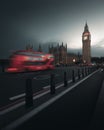 Long exposure shot of a red Double-decker bus in Moody London street with Big Ben tower at sunset Royalty Free Stock Photo