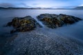 Long exposure shot of rocks in the sea in Moses Point, North Saanich, Vancouver Island, Canada Royalty Free Stock Photo