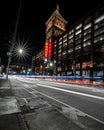 Long exposure shot of traffic lights with the illuminated Ponce City Market in Atlanta at night