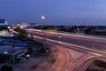 Long exposure shot of traffic while traveling at night on a motorway in Thailand. Abstract animated curved city road with neon