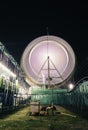 Long Exposure slow shutter speed Shot of a Spinning Ferris Wheel with beautiful lights in indian Fun Fair at night Royalty Free Stock Photo