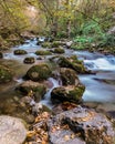 Long exposure smooth flowing water over rocks in forest Royalty Free Stock Photo