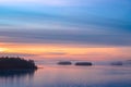 Long Exposure of Sunset at the Paijanne lake. Beautiful scape with sunrise sky, pine forest and water. Lake Paijanne, Finland