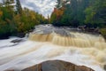 Long exposure of the Tahquamenon Falls waterfall in Michigan surrounded by autumn foliage Royalty Free Stock Photo