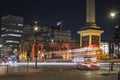 Long exposure of Trafalgar Square with a typical english double decker bus.