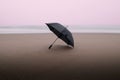 Long exposure of umbrella on the beach during sunset on a rainy cloudy day pastel colors Royalty Free Stock Photo