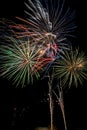 Long exposure vertical photograph of several seconds, of a few colored fireworks rockets exploded