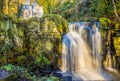 A long exposure view a pair of cascading waterfalls at Lumsdale on Bentley Brook, Derbyshire, UK