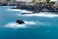 Long exposure view of rocky seashore with deep blue water Royalty Free Stock Photo