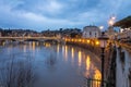 Long exposure view of Rome on a cloudy sunset, Tiber river and bridge with light set. Top view.