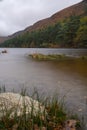 Long exposure view, silky water during autumn in the Wicklow Mountains. Rock on front, Glendalough Upper
