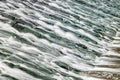 Long exposure of water flowing over algae covered rocks at Lopwell Weir, Plymouth, Devon Royalty Free Stock Photo