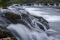 Long exposure of the water sliding through the rocks on a dum Royalty Free Stock Photo