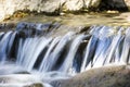 Long exposure waterfall cascades over rocks with multiple streams