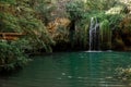 Long exposure waterfall during the day. green forest and rocky mountain. summer time. crystal clear blue water Royalty Free Stock Photo