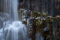 Long exposure of waterfall over basaltic rocks with ice Royalty Free Stock Photo