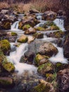 Long exposure waterfall over rocks in forest landscape Royalty Free Stock Photo