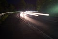 Traffic at Night - White Light Trails around a Highway Corner Royalty Free Stock Photo