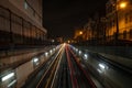 Long exposure white and red light trails from the CTA trains departing and coming from an underground tunnel at night with alley Royalty Free Stock Photo