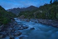 long exposure of a wild mountain river at night, lit by moonlight.